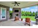 Inviting covered patio featuring brickwork, a ceiling fan, and a view of the lush backyard at 2715 Benmore Ct, Zionsville, IN 46077