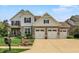 Charming two-story home boasts a three-car garage, landscaped yard, and classic brick and siding exterior at 2715 Benmore Ct, Zionsville, IN 46077