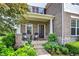 Charming front porch with rocking chairs, potted plants, and a beautifully landscaped garden at 2715 Benmore Ct, Zionsville, IN 46077