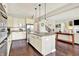 Gourmet kitchen with stainless appliances, center island, and open view to the Gathering room and staircase at 2715 Benmore Ct, Zionsville, IN 46077