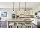 Well-lit kitchen island with granite countertops, pendant lighting, and stainless steel appliances at 2715 Benmore Ct, Zionsville, IN 46077