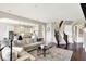 Open-concept living room featuring a large sectional sofa, hardwood floors, and seamless access to the kitchen at 2715 Benmore Ct, Zionsville, IN 46077