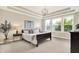 Serene main bedroom with trey ceilings, a cozy bed, a decorative ceiling fan, and large windows with natural light at 2715 Benmore Ct, Zionsville, IN 46077