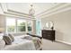 Bright main bedroom with large windows, a comfortable bed, and stylish decor, providing a relaxing atmosphere at 2715 Benmore Ct, Zionsville, IN 46077