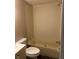 Bathroom features a standard bathtub and toilet with vinyl tile flooring at 3042 S Conservation Club Rd, Morgantown, IN 46160