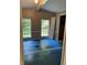 Bedroom needing renovation features blue floor and natural light through windows at 3042 S Conservation Club Rd, Morgantown, IN 46160