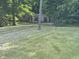 Single-story home with a deck nestled amongst mature trees, offering natural beauty and privacy at 3042 S Conservation Club Rd, Morgantown, IN 46160