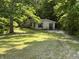 Charming single-story home with a well-maintained lawn and surrounded by mature trees at 3042 S Conservation Club Rd, Morgantown, IN 46160