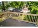 A view of the back yard from the new deck, including a fenced yard with mature trees at 3246 N New Jersey St, Indianapolis, IN 46205
