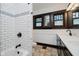 Bathroom with updated tile, modern vanity, and combined shower and tub at 3246 N New Jersey St, Indianapolis, IN 46205