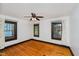 A bright bedroom with hardwood floors, a ceiling fan, and updated windows with wood trim at 3246 N New Jersey St, Indianapolis, IN 46205