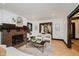 Bright living room with a brick fireplace, comfortable seating, and hardwood floors, creating a warm atmosphere at 3246 N New Jersey St, Indianapolis, IN 46205