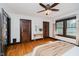 Sunlit bedroom with hardwood floors, ceiling fan, and ample closet space at 3246 N New Jersey St, Indianapolis, IN 46205