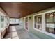 Covered porch featuring a wood ceiling, windows, and view of the neighborhood from the home's entrance at 3246 N New Jersey St, Indianapolis, IN 46205