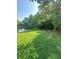 Scenic backyard with lush trees and a fire pit at 3350 Shore Dr, Greenwood, IN 46143
