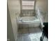 Close up of bathtub with decorative tile, tiled trim and natural lighting at 3350 Shore Dr, Greenwood, IN 46143