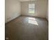 Spacious bedroom featuring neutral carpeting and natural light from a window at 3350 Shore Dr, Greenwood, IN 46143