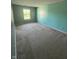 Spacious bedroom with neutral carpeting, one window and calming, soft blue accent walls at 3350 Shore Dr, Greenwood, IN 46143