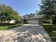 Charming two-story home with a well-maintained lawn, mature trees, and long driveway leading to a two-car garage at 3350 Shore Dr, Greenwood, IN 46143