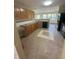 Functional kitchen area featuring granite counters, ample cabinet space, and durable tile flooring at 3350 Shore Dr, Greenwood, IN 46143