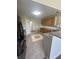 Well-lit kitchen featuring granite countertops, tiled floors, wooden cabinets, and modern appliances at 3350 Shore Dr, Greenwood, IN 46143
