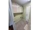 Functional laundry room features tile flooring and cabinets for storage at 3350 Shore Dr, Greenwood, IN 46143