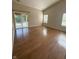 Open living room with beautiful hardwood floors, natural light, and sliding doors at 3350 Shore Dr, Greenwood, IN 46143