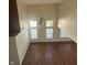 Open-concept living room with hardwood floors, a ceiling fan, and large windows at 3350 Shore Dr, Greenwood, IN 46143