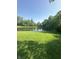 Lush lawn with a clear pond in the background at 3350 Shore Dr, Greenwood, IN 46143