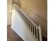 Classic white staircase connecting the levels of the home with carpeted steps and a light tan wall at 3350 Shore Dr, Greenwood, IN 46143