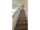 Carpeted stairway with white handrail provides access to the upper level at 3350 Shore Dr, Greenwood, IN 46143