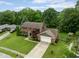 Aerial view showcasing the brick home, attached garage, mature landscaping, and driveway at 3439 Eden Park Dr, Carmel, IN 46033