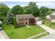 Aerial view of the home with manicured lawn, mature trees, and a driveway leading to an attached garage at 3439 Eden Park Dr, Carmel, IN 46033