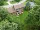 Aerial view of the house and backyard featuring a deck, lush green lawn, and surrounding trees at 3439 Eden Park Dr, Carmel, IN 46033