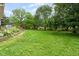 Expansive backyard featuring a lush lawn, mature trees, and a deck, ideal for outdoor enjoyment at 3439 Eden Park Dr, Carmel, IN 46033