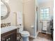 Bathroom featuring a vanity, round mirror, and walk-in shower with tile surround at 3439 Eden Park Dr, Carmel, IN 46033