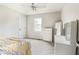 Well-lit bedroom with neutral paint, ceiling fan, closet, and large mirror at 3439 Eden Park Dr, Carmel, IN 46033
