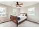 Bedroom with ceiling fan, two windows, neutral walls, and plush carpet at 3439 Eden Park Dr, Carmel, IN 46033