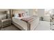 Comfortable bedroom with a upholstered bed, bedside lamps, and natural light from the window at 3439 Eden Park Dr, Carmel, IN 46033