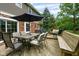 Relaxing outdoor deck featuring an umbrella, dining table, chairs, and bench seating for delightful entertaining at 3439 Eden Park Dr, Carmel, IN 46033