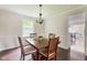 Traditional dining room with dark wood table and a window with natural light at 3439 Eden Park Dr, Carmel, IN 46033