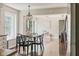 Dining area with hardwood floors, modern light fixture, and backyard view at 3439 Eden Park Dr, Carmel, IN 46033