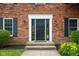 Elegant front entrance with black door, sidelights, and manicured landscaping at 3439 Eden Park Dr, Carmel, IN 46033