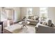 Bright living room with neutral tones, hardwood floors, and lots of natural light at 3439 Eden Park Dr, Carmel, IN 46033