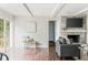 Cozy living room with a brick fireplace, built-in shelving, and hardwood floors at 3439 Eden Park Dr, Carmel, IN 46033