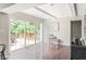 Sunlit living room featuring hardwood floors and sliding glass doors to the backyard deck at 3439 Eden Park Dr, Carmel, IN 46033