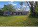 Spacious backyard featuring a trampoline, grill, and covered patio at 3509 N Wittfield St, Indianapolis, IN 46235