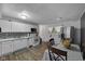 Eat-in kitchen with white cabinetry, stainless steel appliances, and hardwood floors, perfect for Gathering meals at 3509 N Wittfield St, Indianapolis, IN 46235