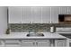 Bright kitchen featuring white cabinets, modern countertops, and a stylish tile backsplash at 3509 N Wittfield St, Indianapolis, IN 46235