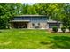 Spacious two-story home with a large backyard, covered patio, attached garage, and lush green lawn at 3715 Rolling Springs Dr, Carmel, IN 46033